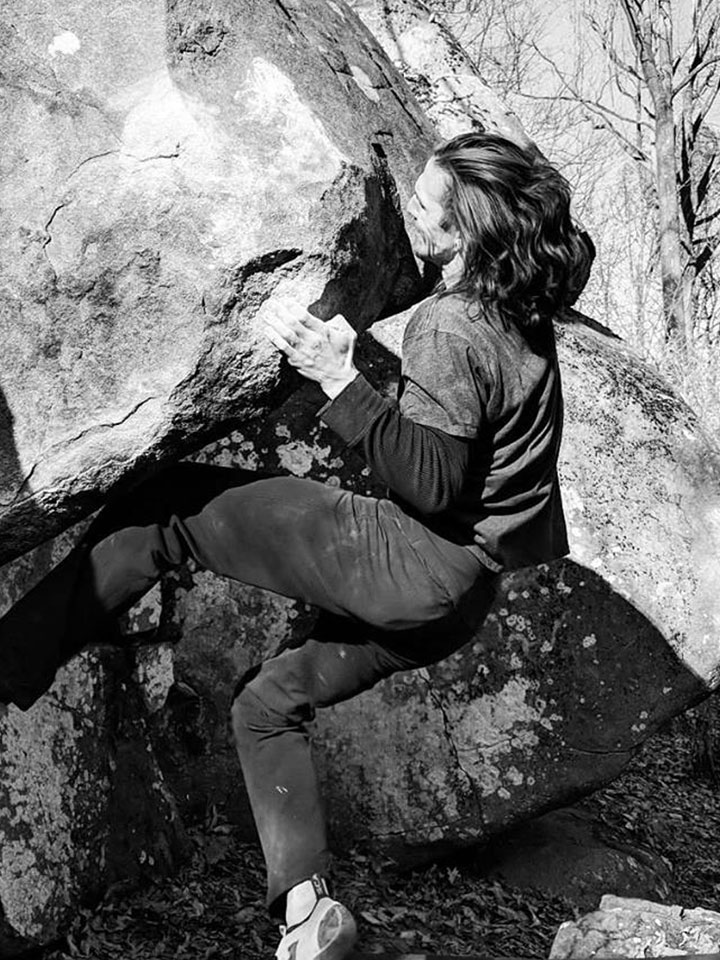 Tom Meehan climbing a rock face